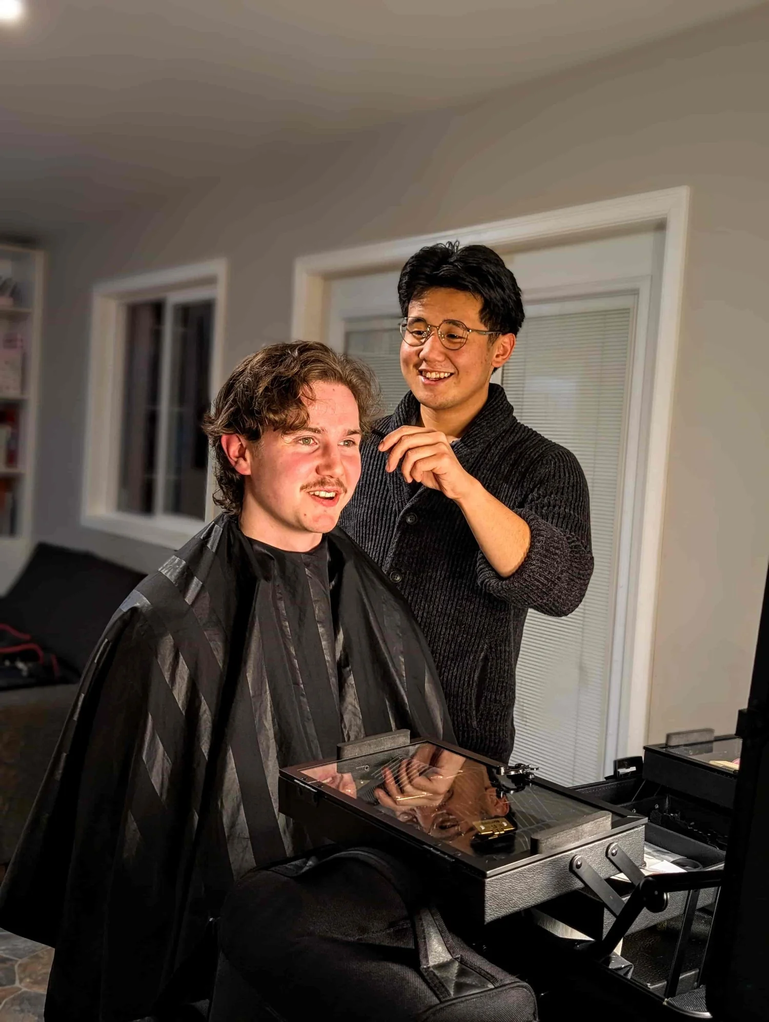 Danny Qin, a mobile barber serving Victoria BC, working with a client during a haircut